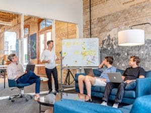 A few men listening to a presentation being made as an example of clear communication and collaboration