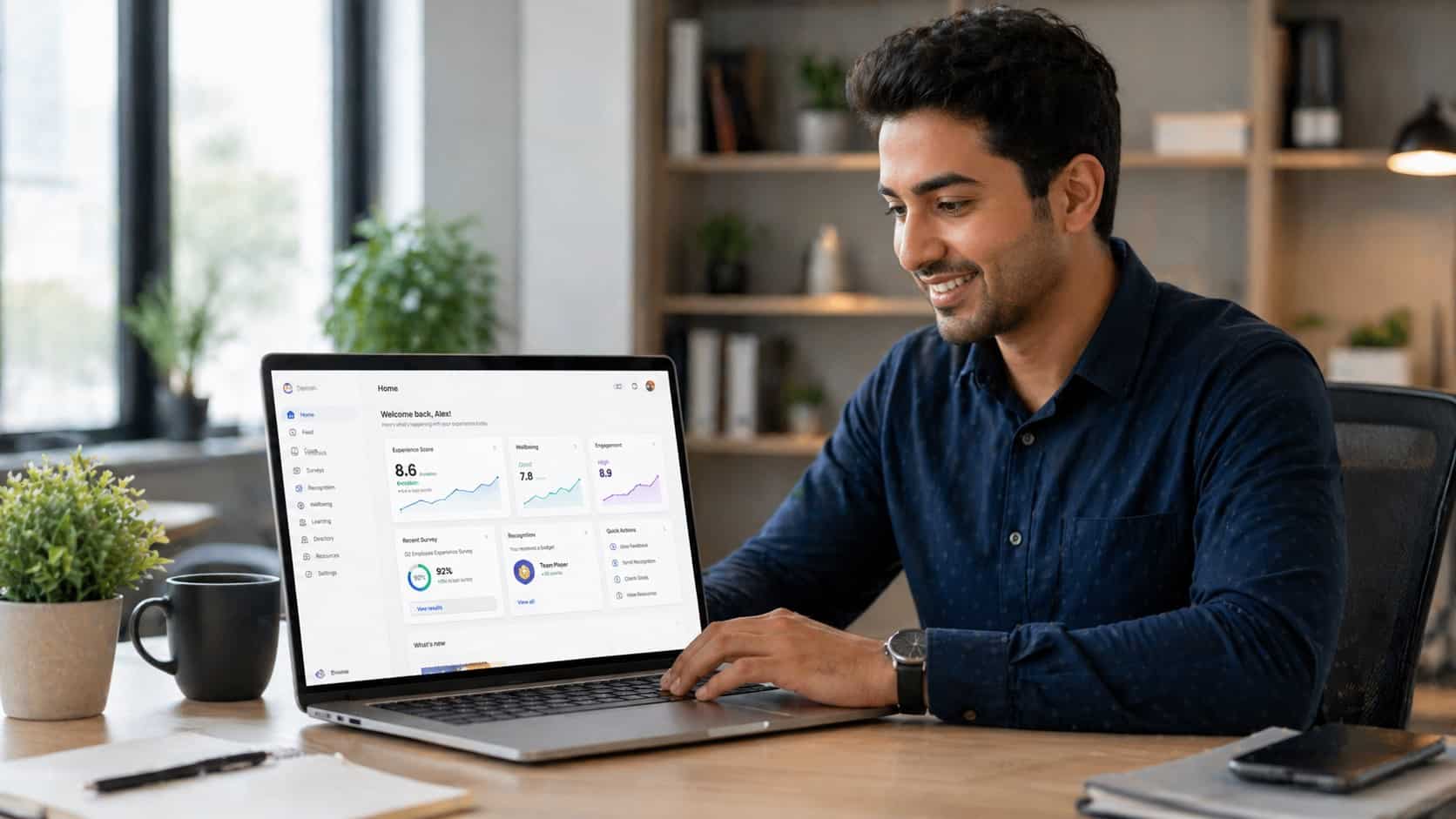 Employee using modern employee experience tools dashboard on laptop in a bright, clean workspace