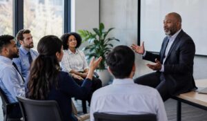 Employees participating in a leadership discussion session with strategic questions to ask CEO in a modern office meeting.